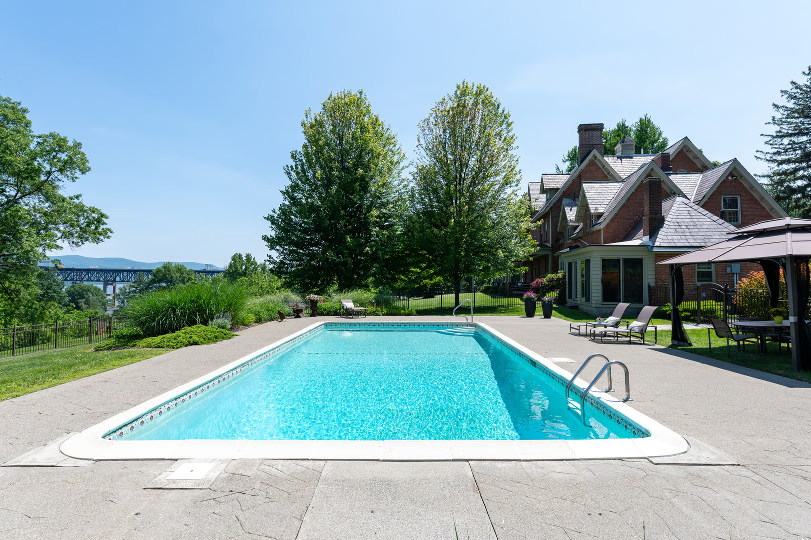 in-ground pool with view of house