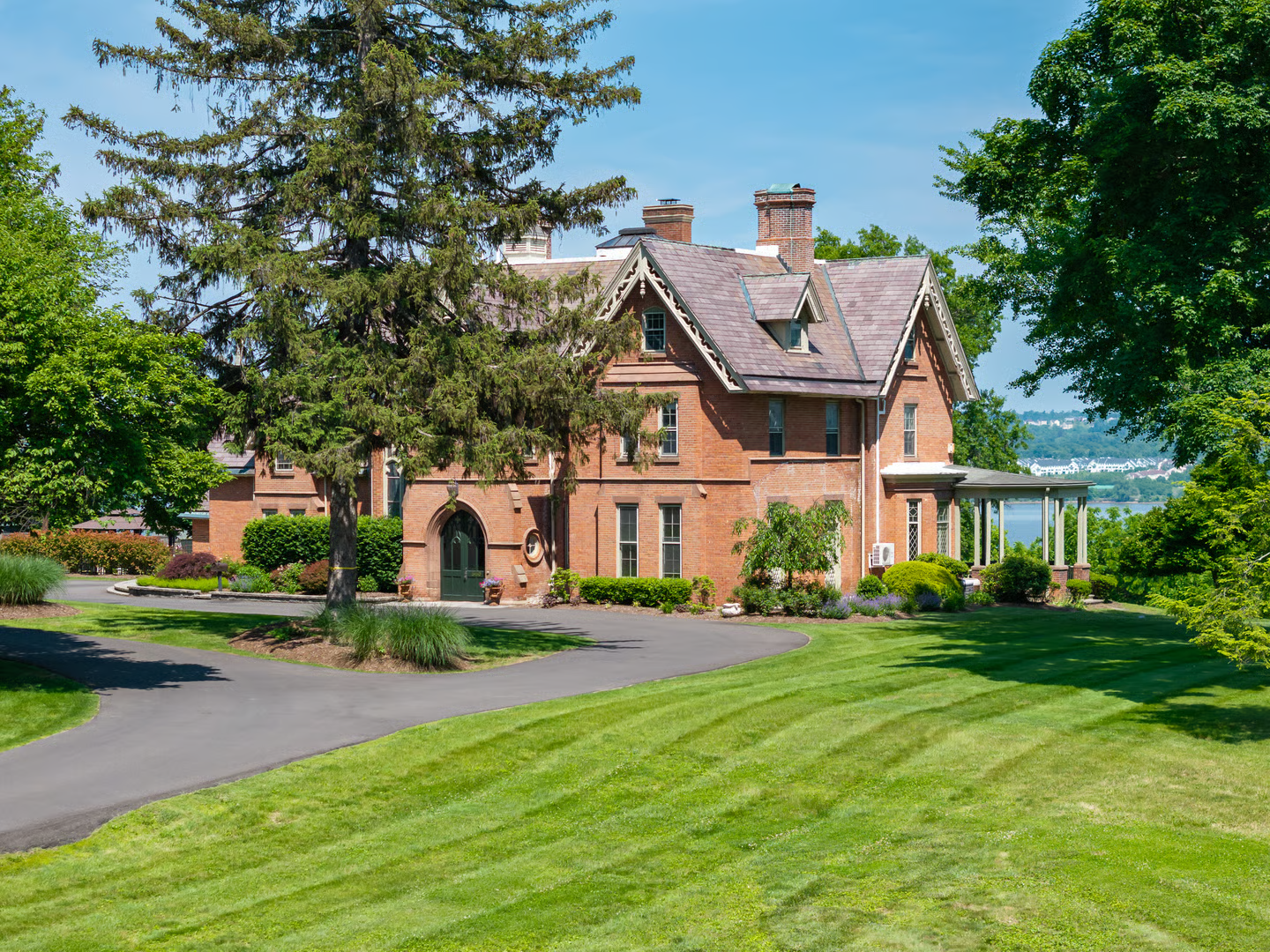 brick exterior with driveway