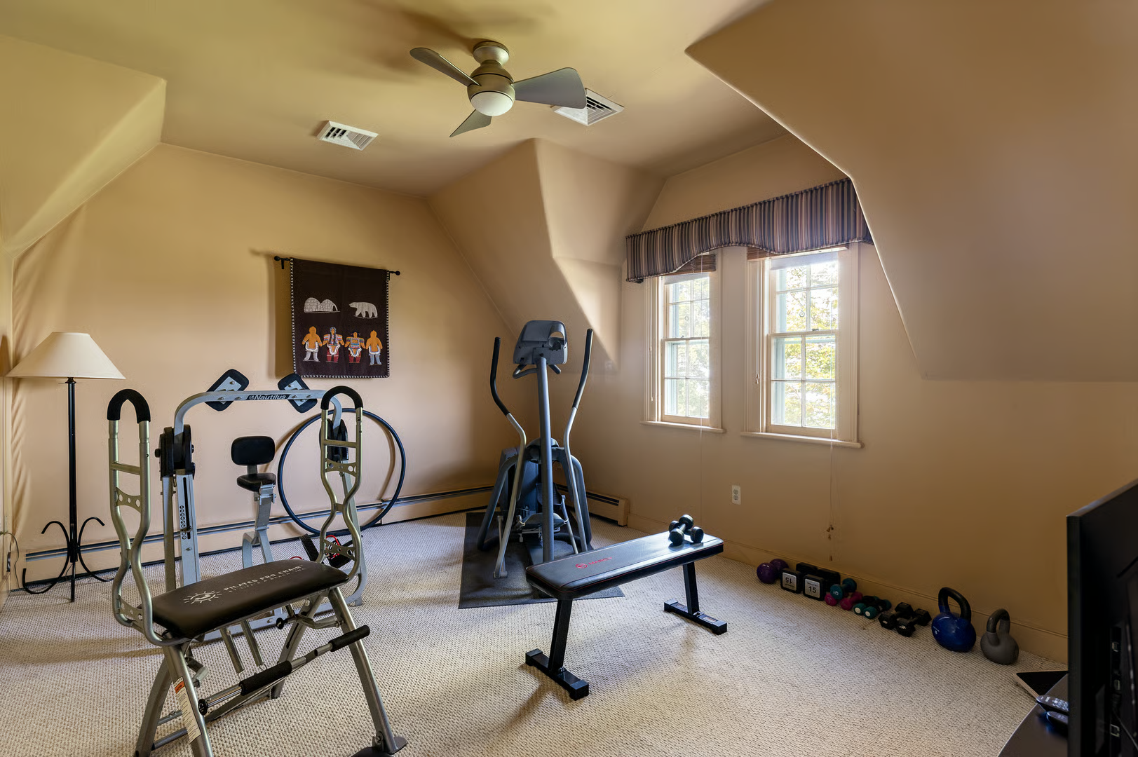 bedroom set up as a gym with wall-to-wall carpet