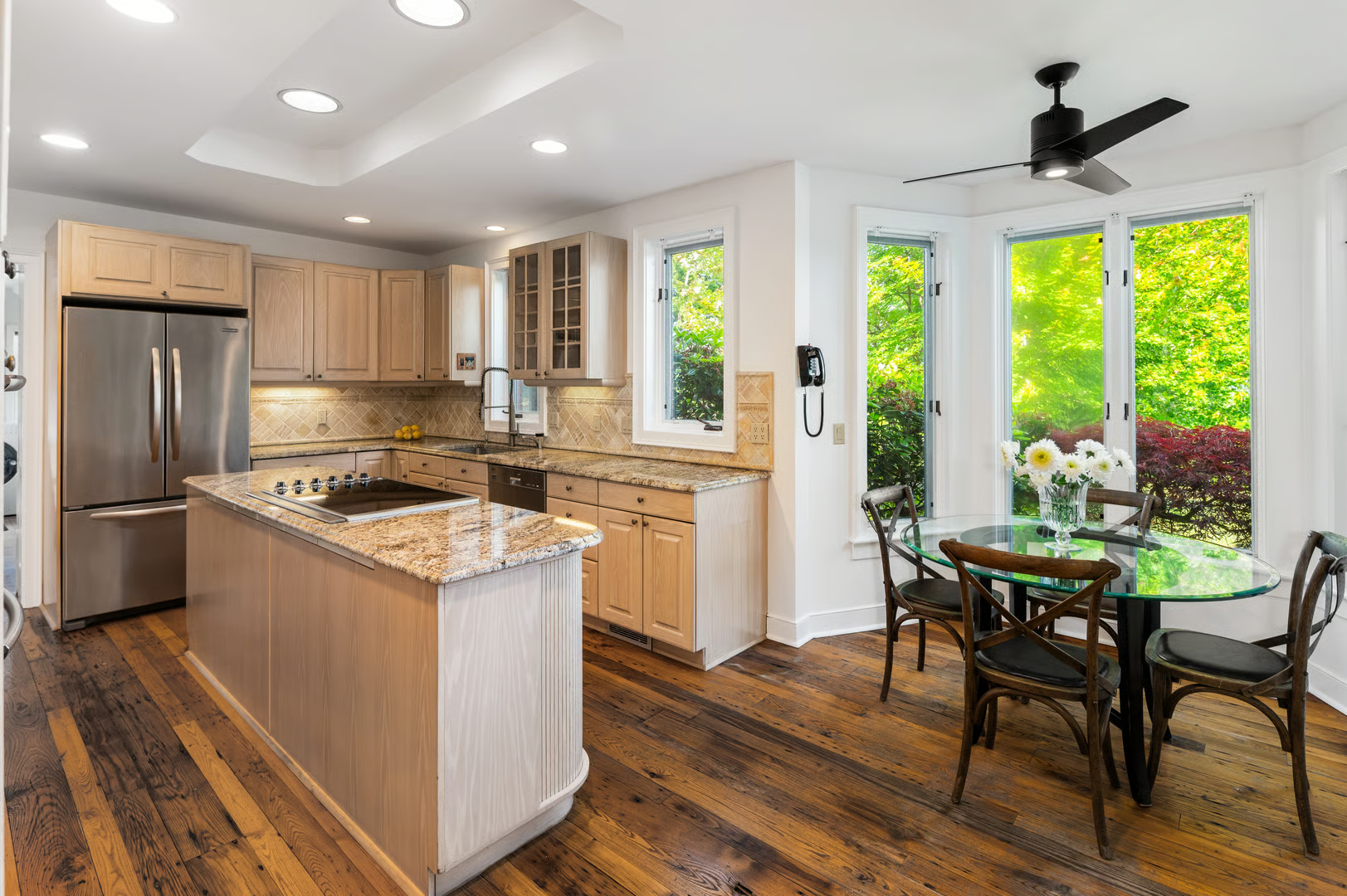 kitchen with pale wood cabinets, room for dining