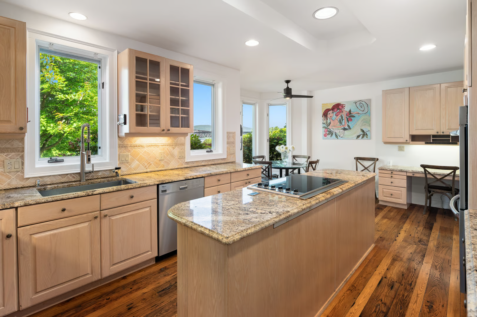 kitchen with pale wood cabinets, room for dining