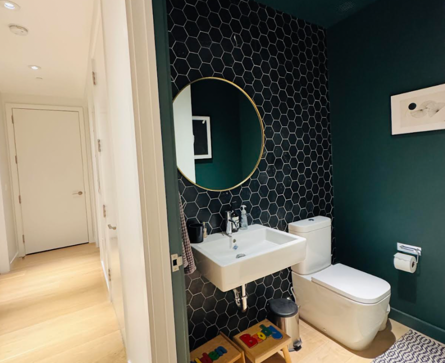 bathroom with white fixtures, green walls