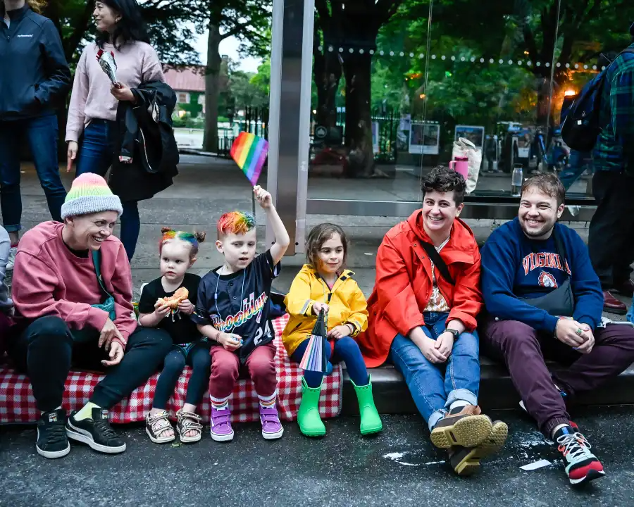 Children watch with excitement as marchers pass by during the 29th annual Brooklyn Pride Parade on Fifth Avenue in Park Slope.