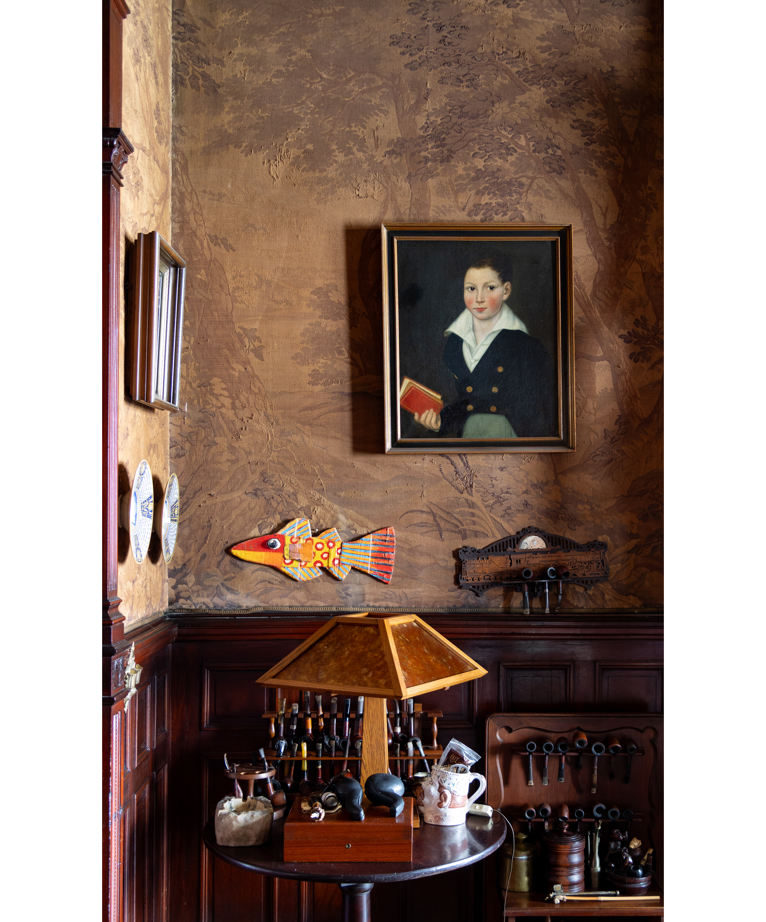 artwork in the rear parlor including a painting of a child