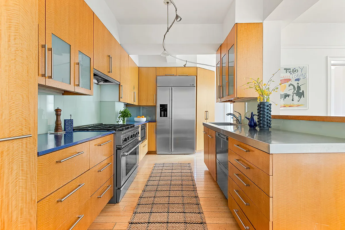 kitchen with wood cabinets, view into living room