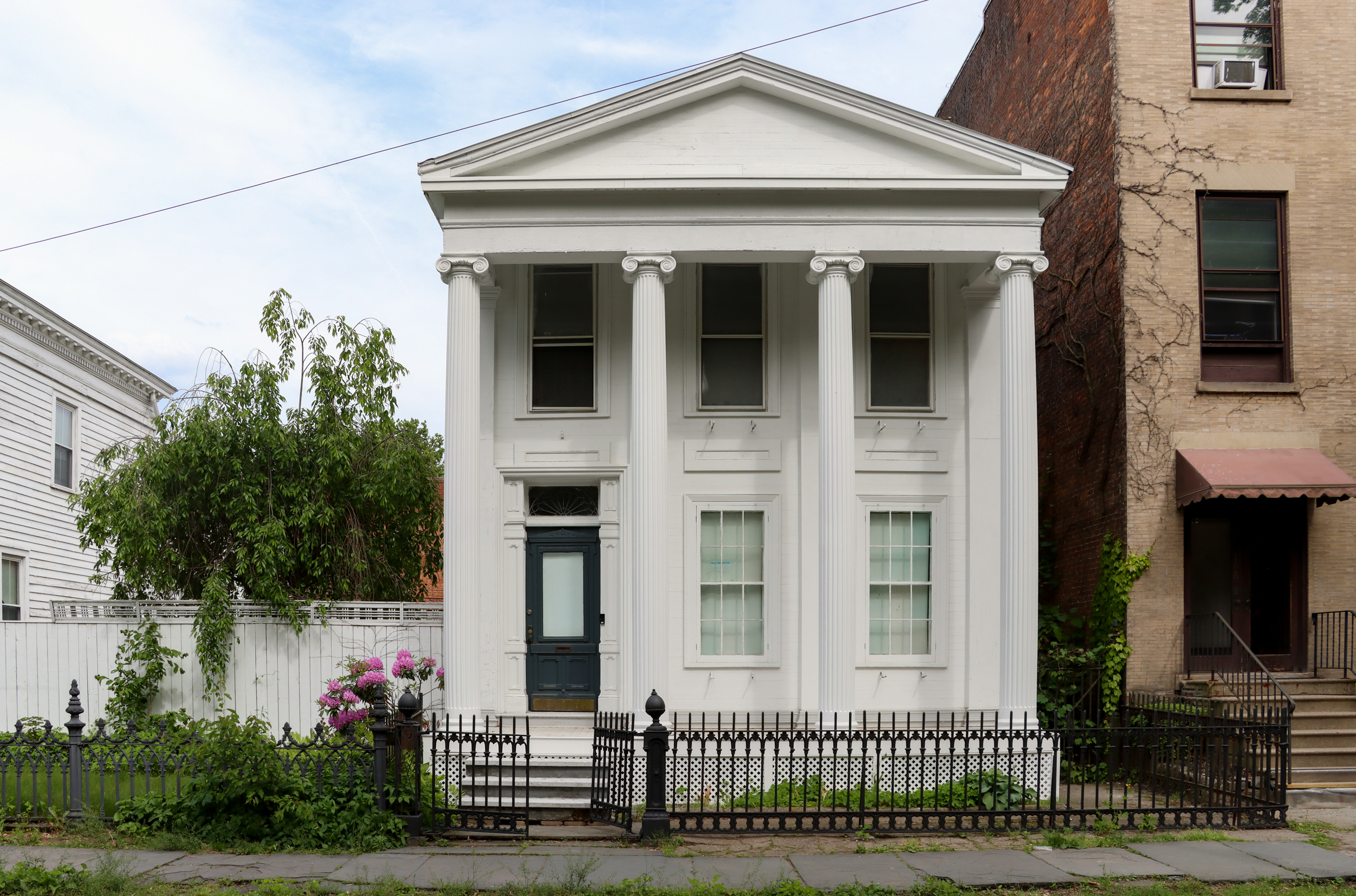 greek revival style house with temple front