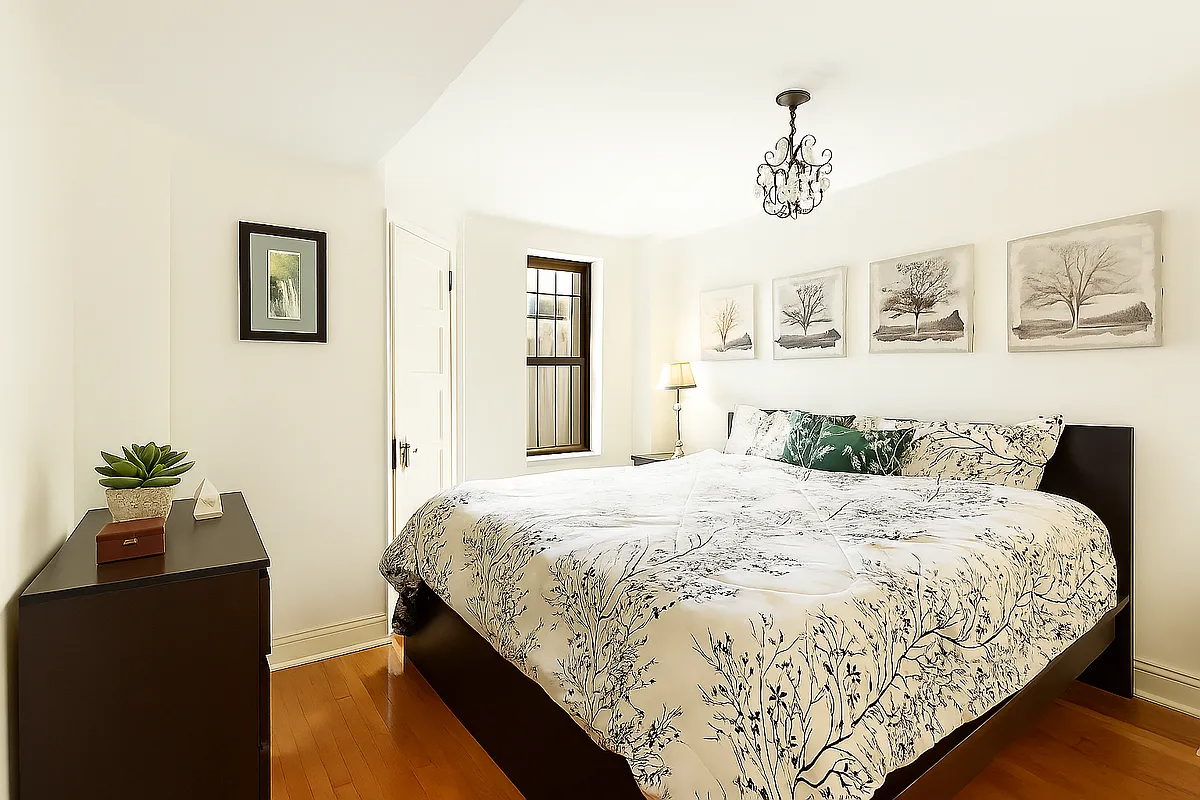 bedroom with small window and a corner closet