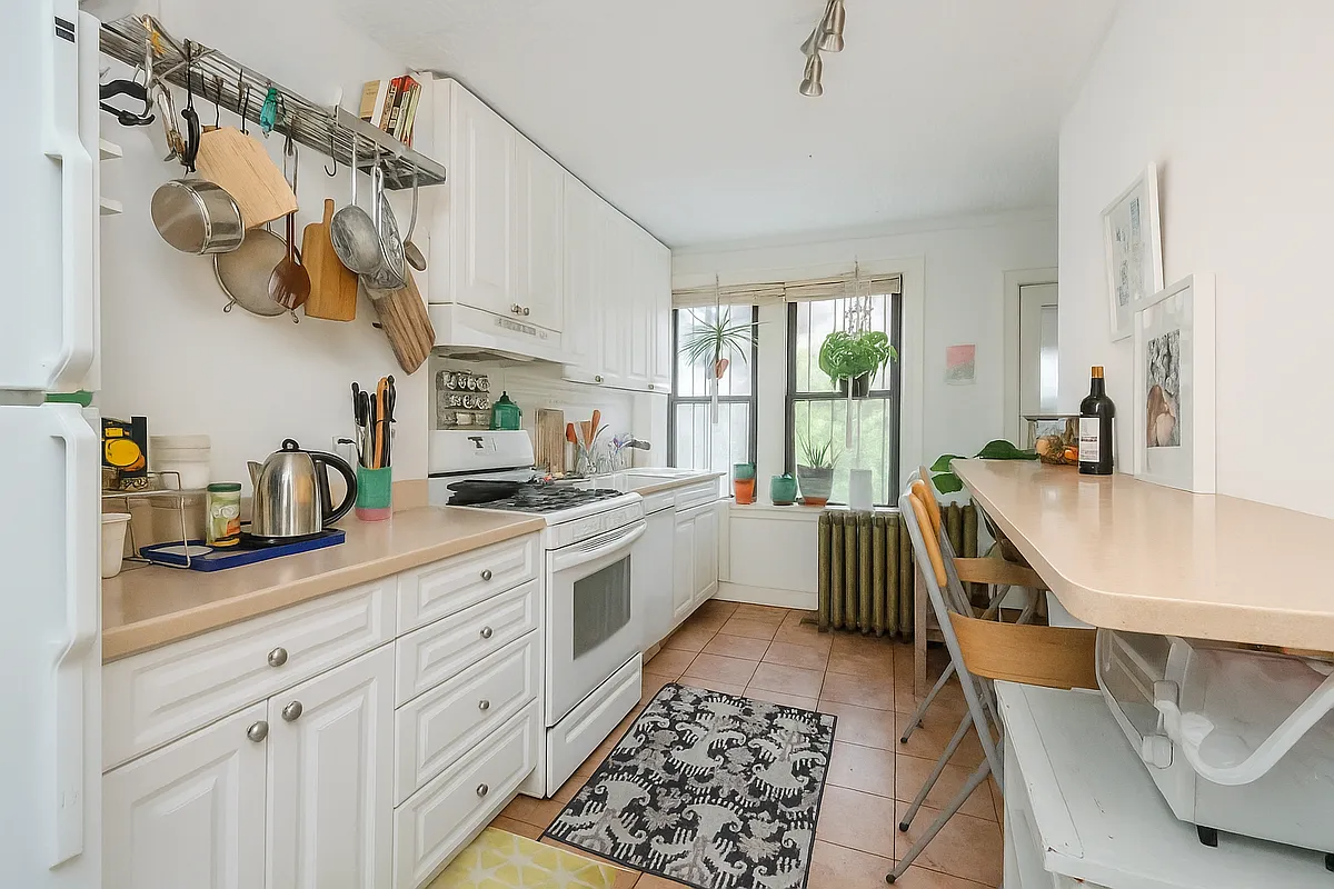 kitchen with windows, tile floor and white cabinets