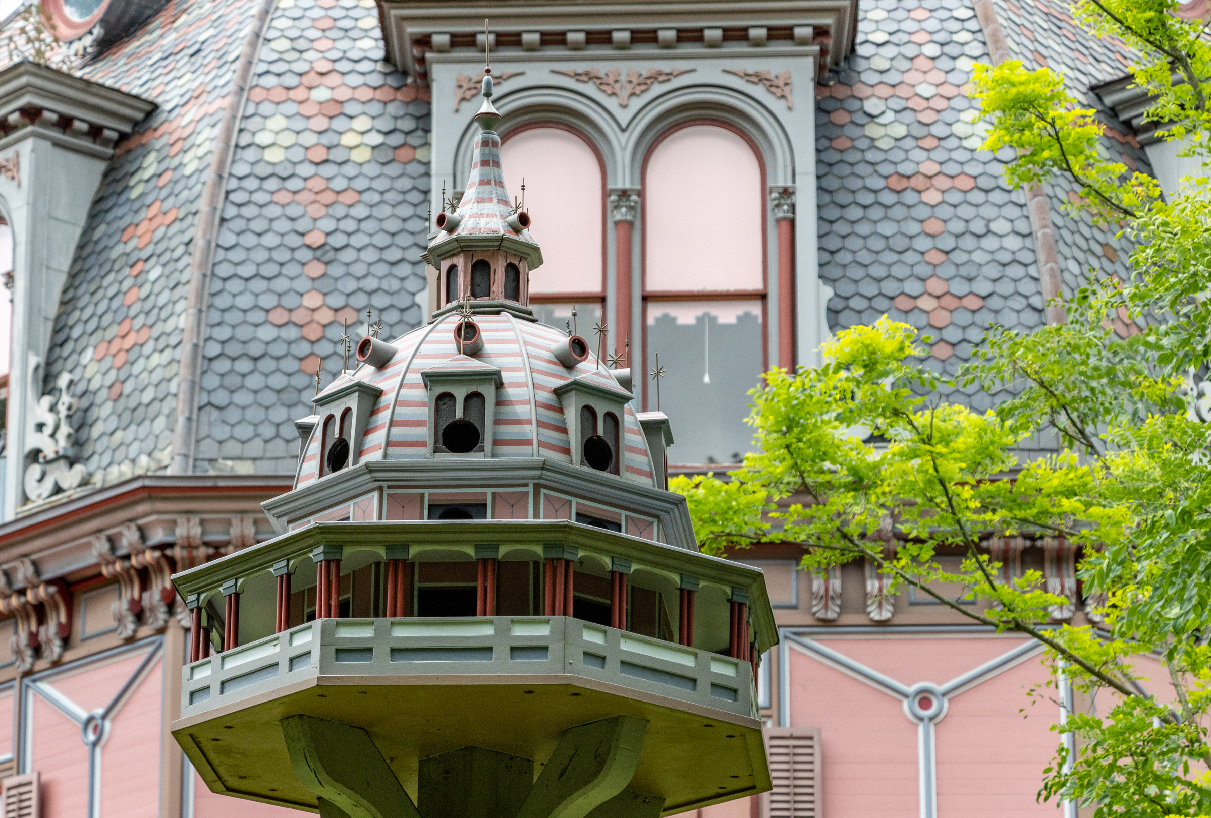 a bird house modelled on the octagon house behind it