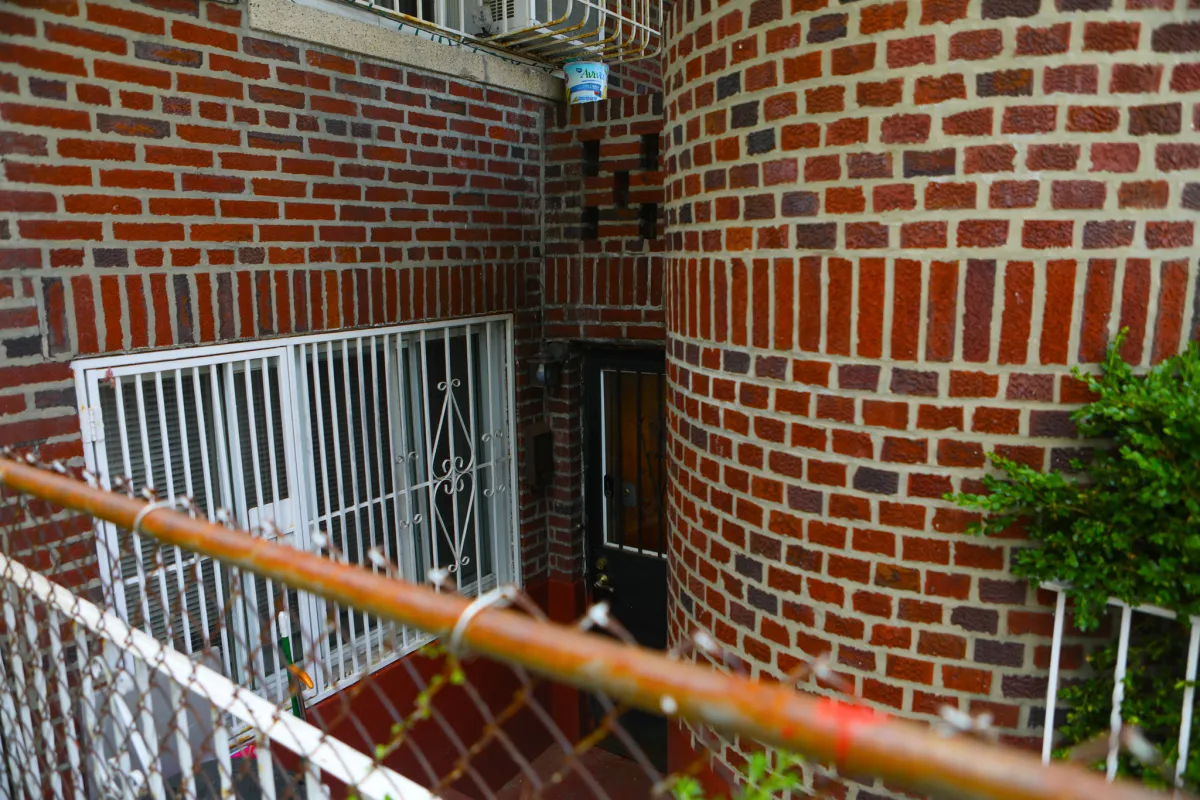 a brick building with a basement door
