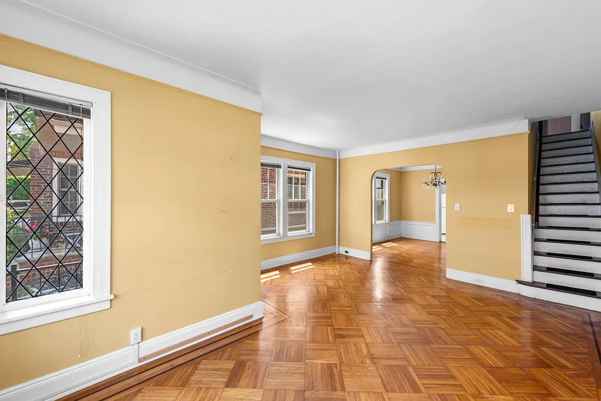 a living room with a wood floor and yellow walls