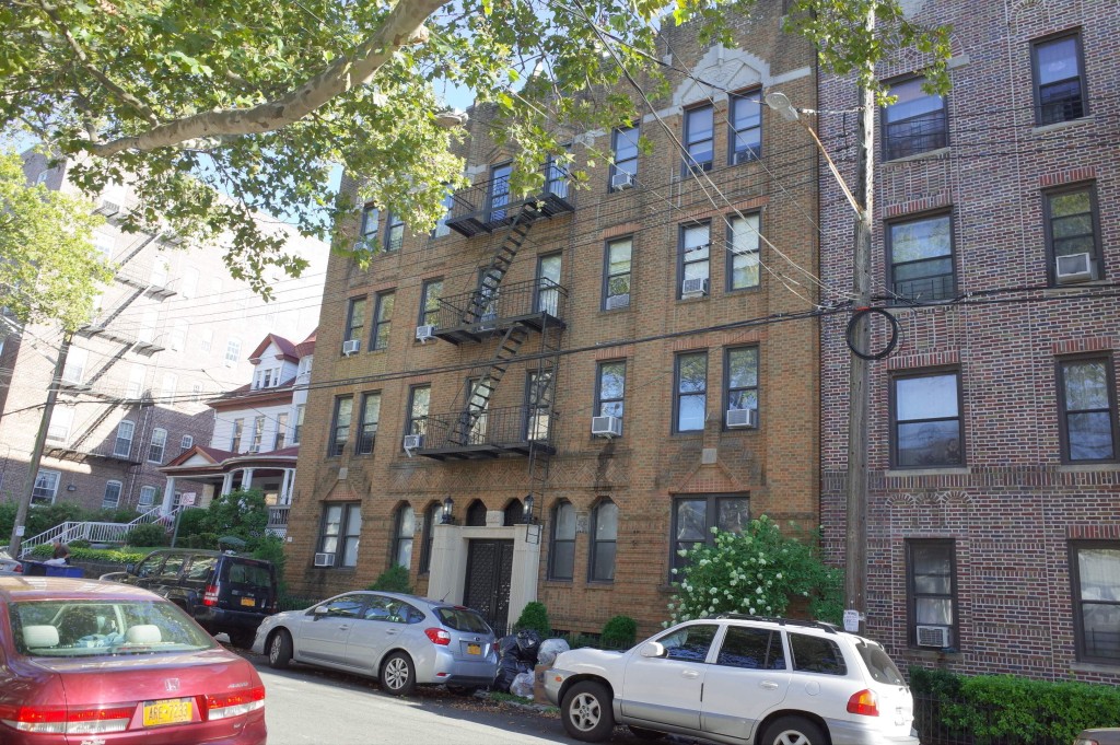 pale brick four story apartment building