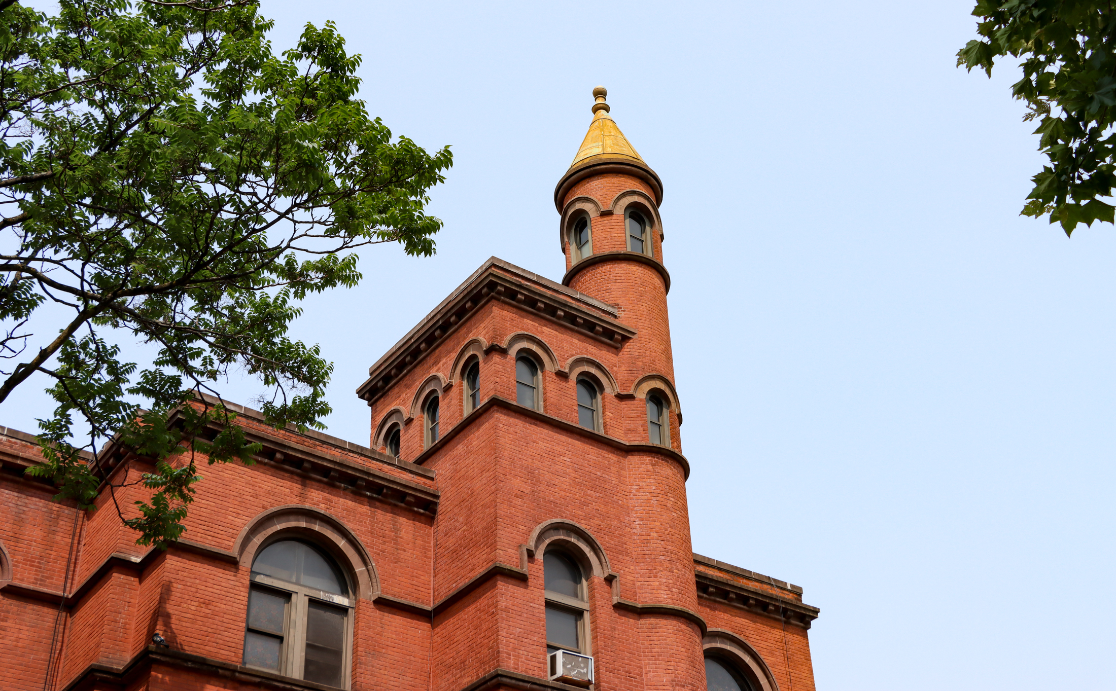 19th century red brick building with a turret housing the 88th precinct in bed stuy