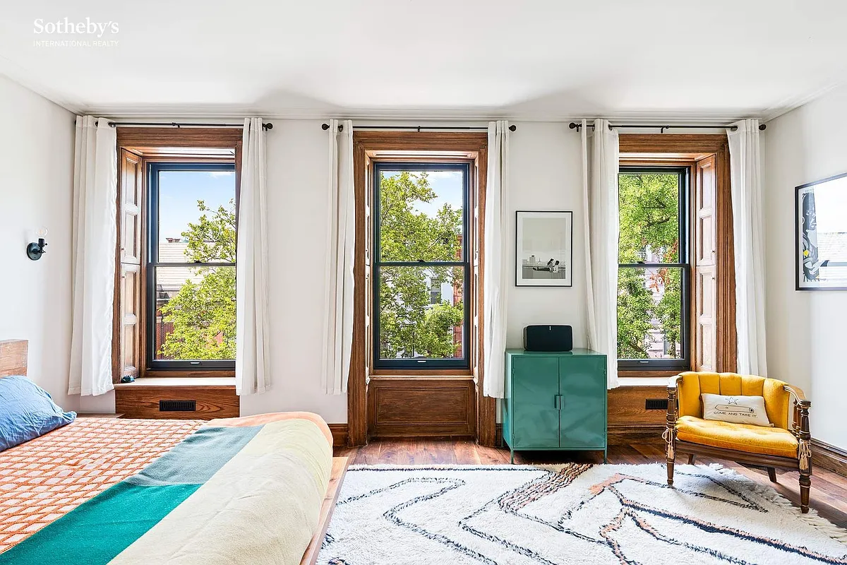 bedroom with three windows with original shutters