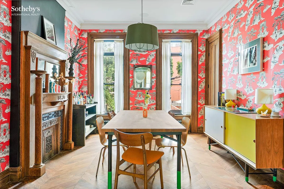 parlor level dining room with red toile wallpaper and a mantel
