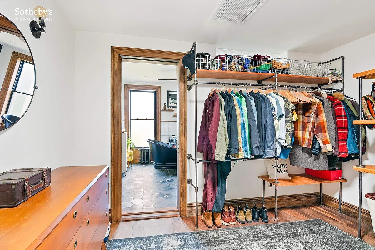 walk-in-closet with door leading to bathroom