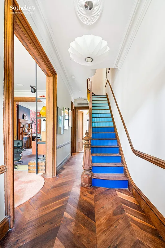 entry hall with a staircase with gradient blue risers