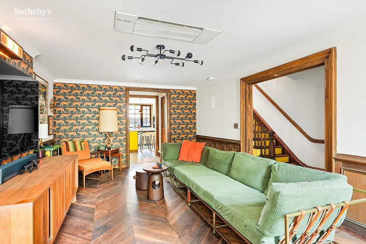 dining room on the garden level with wainscoting set up as a casual living room
