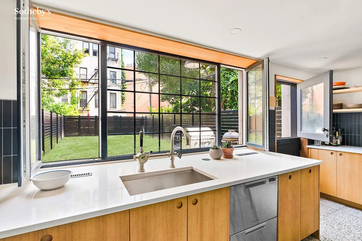 kitchen with wall of glass and door to the rear yard