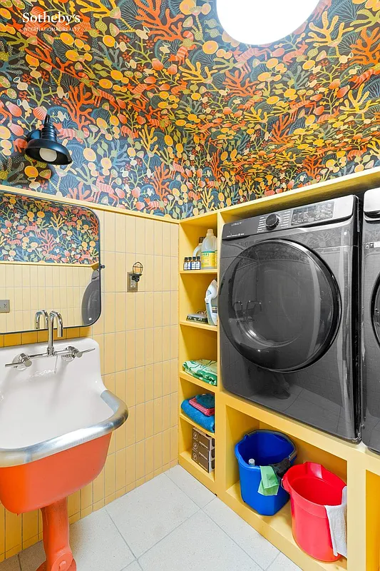 laundry room with bright wallpaper, orange sink