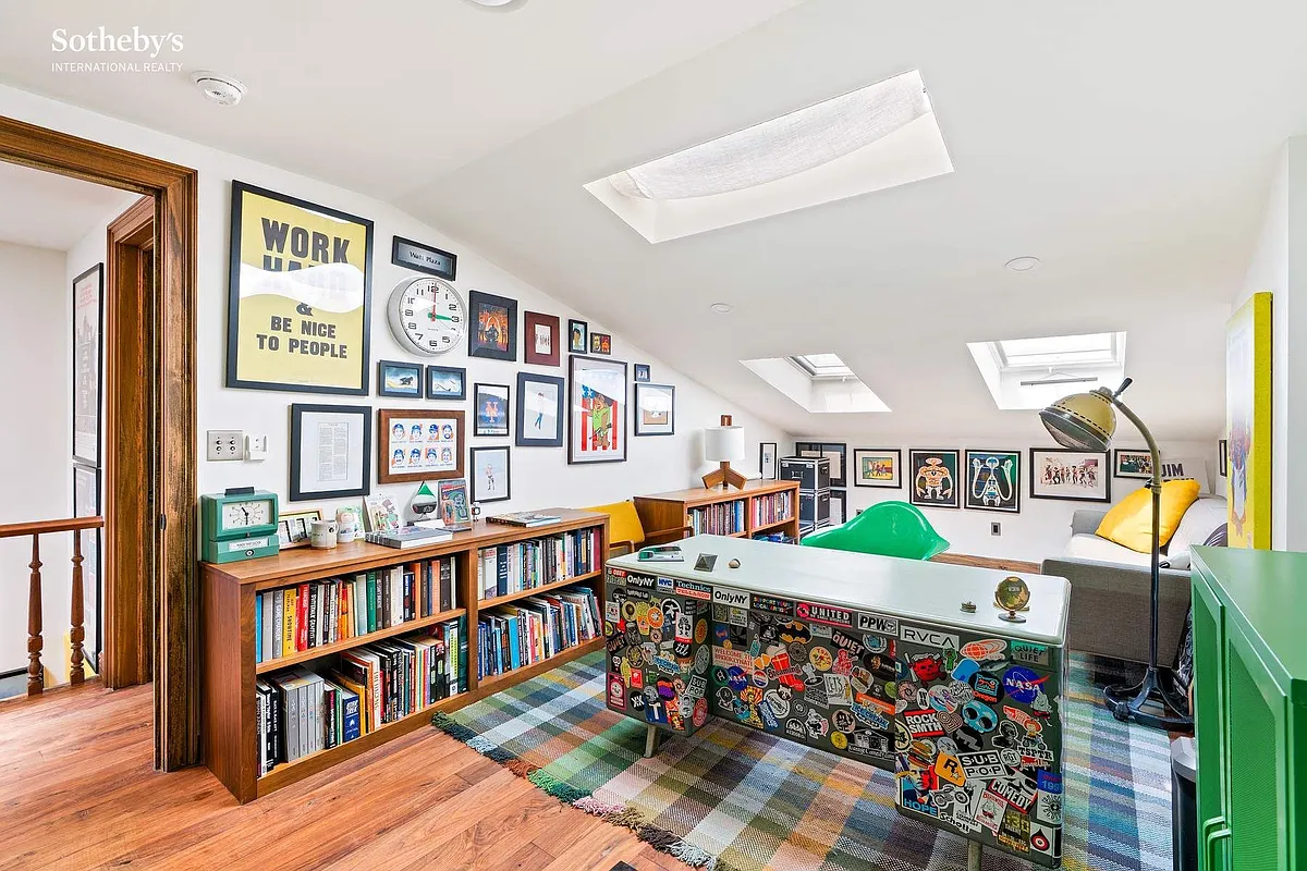 an office with multiple skylights, room for bookshelves