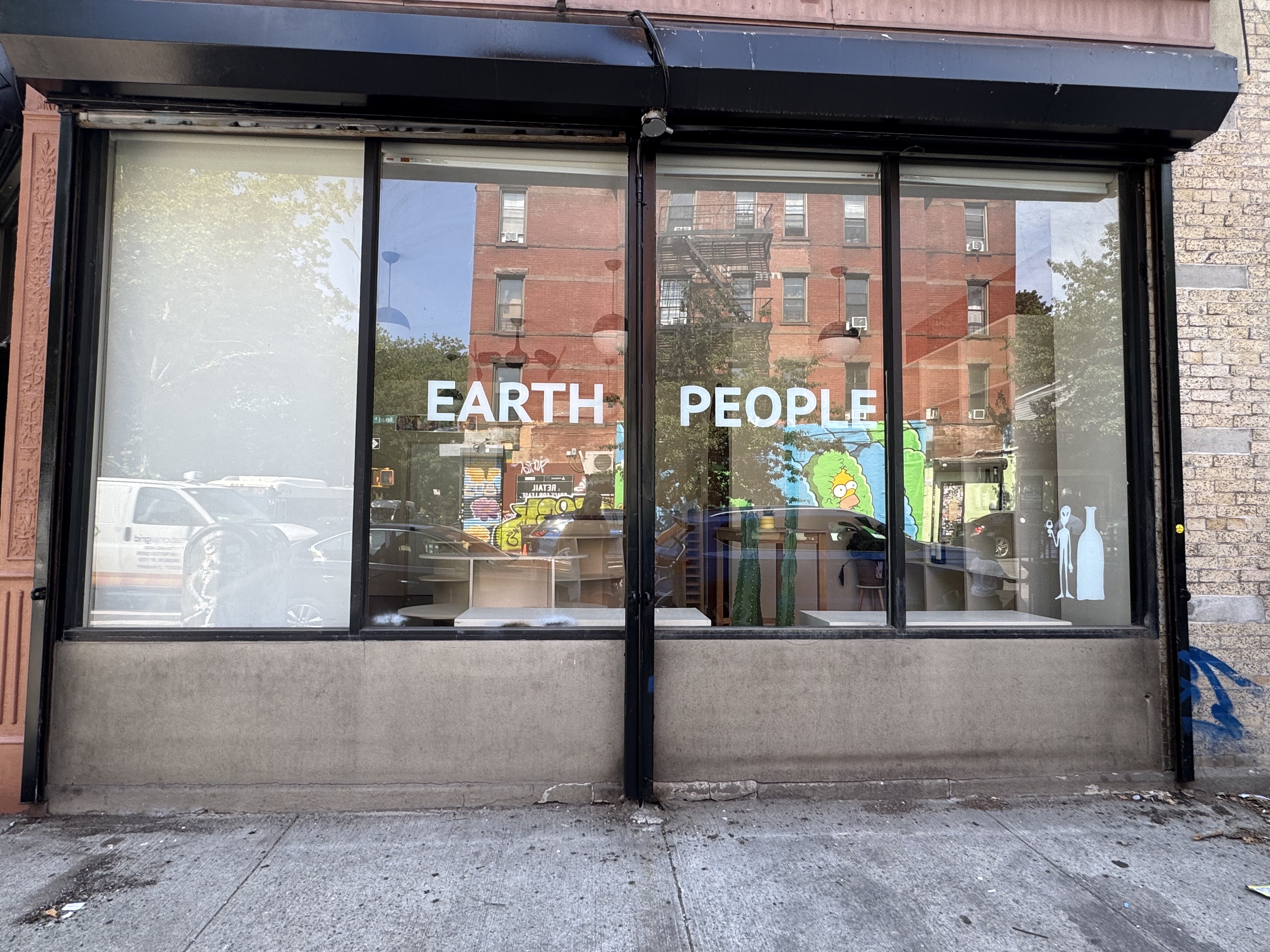 storefront window with earth people on the glass