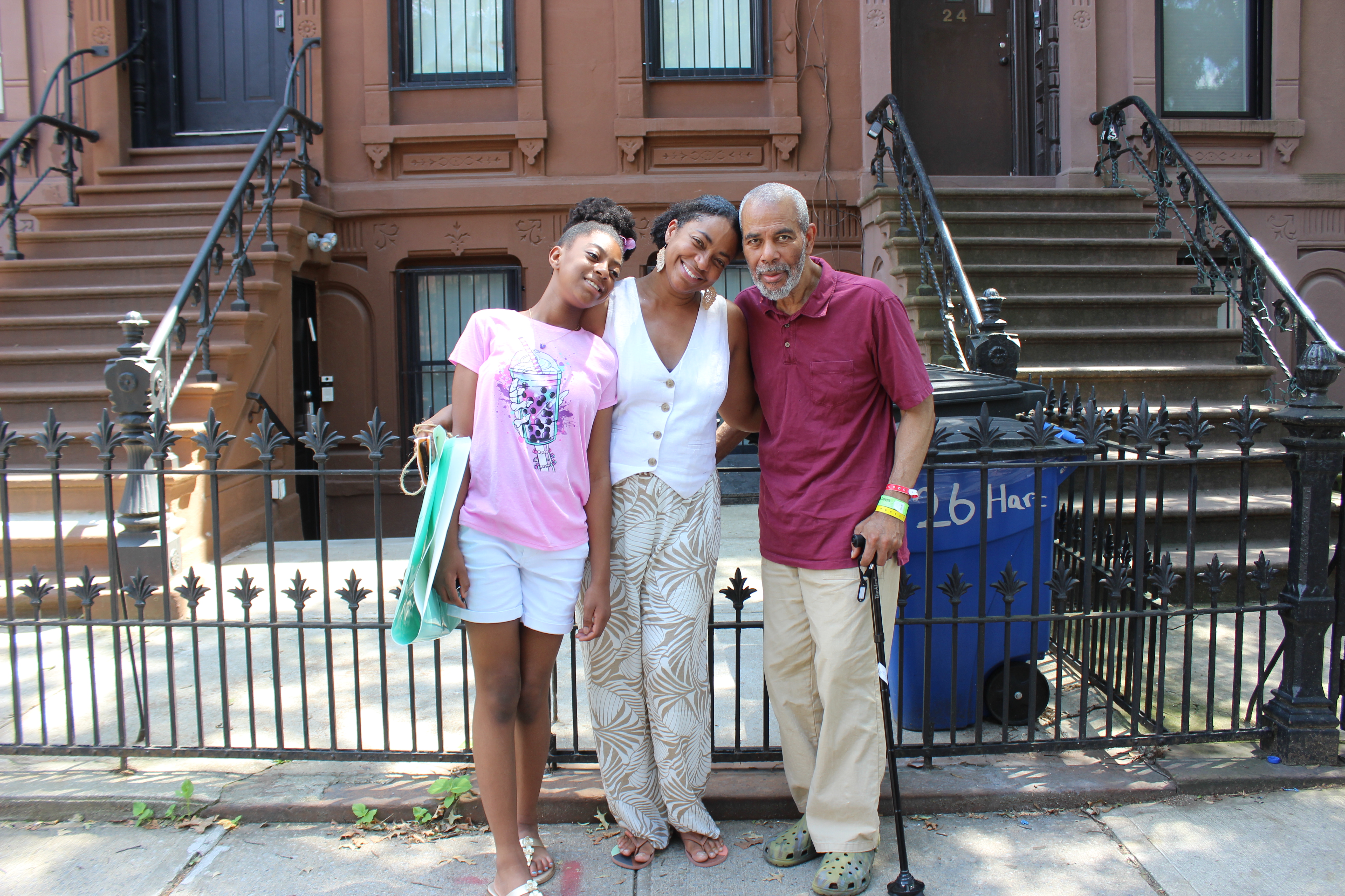 family outside a brownstone on Hart Street