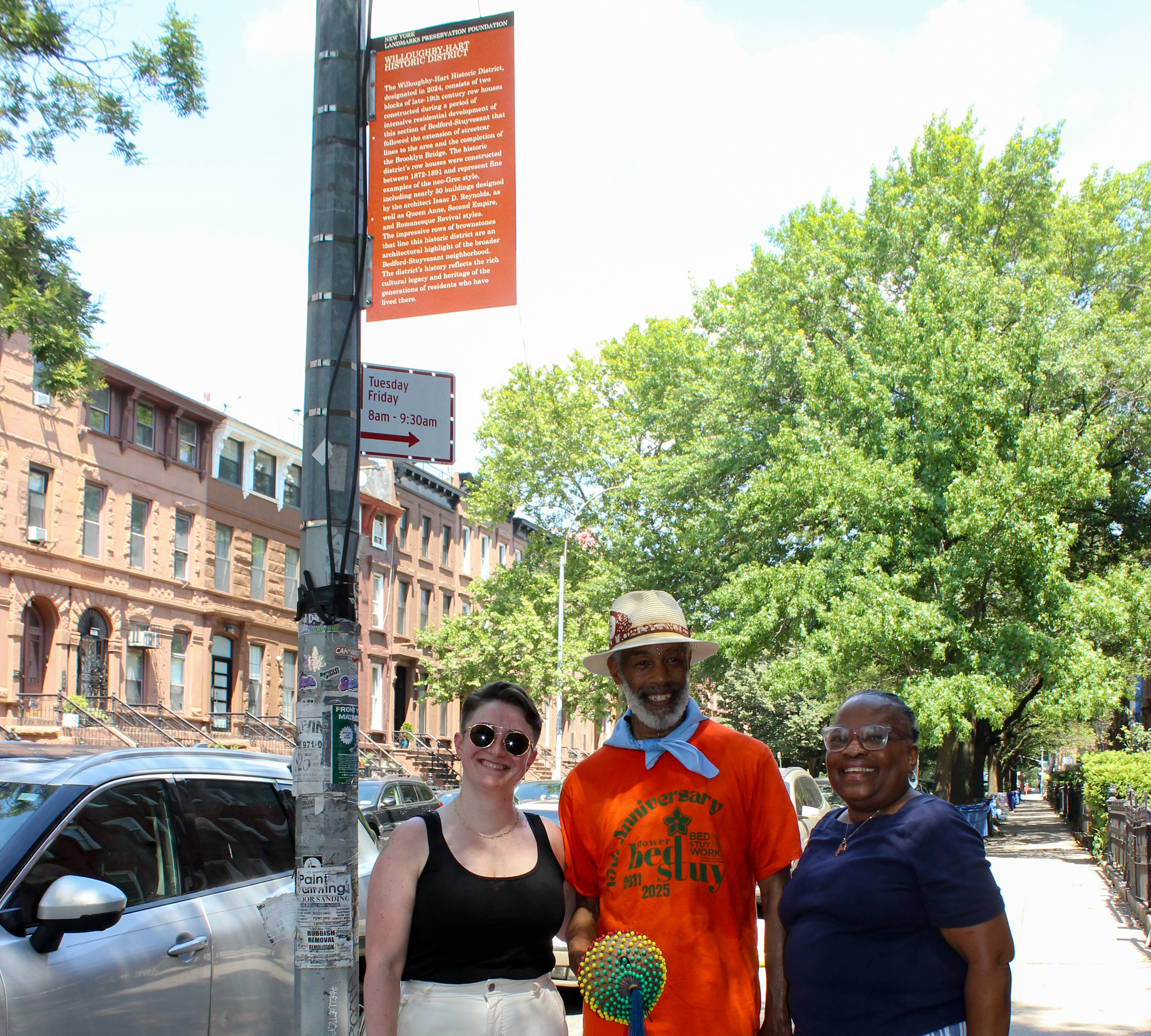 group gathered under historic district marker