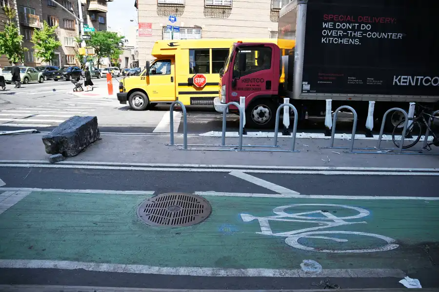 a protected bike lane with traffic on the other side