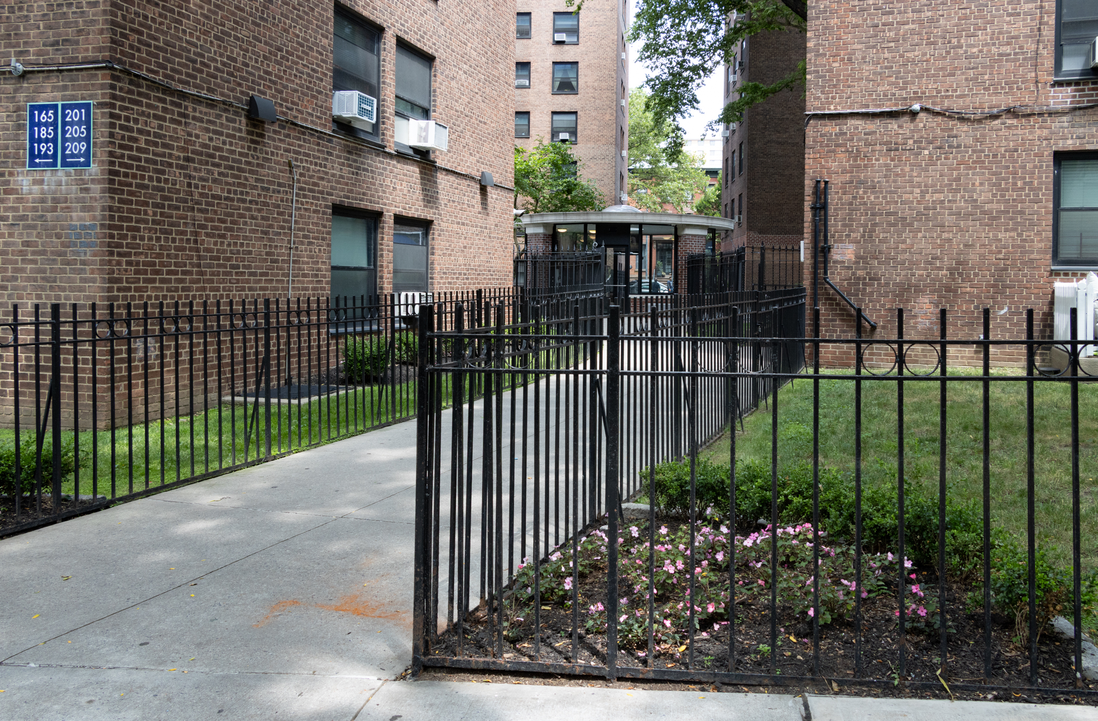 iron fence around a lawn and a round guard house