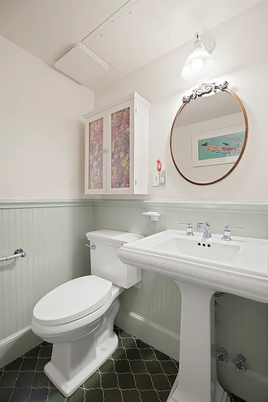 bathroom with beadboard, white fixtures