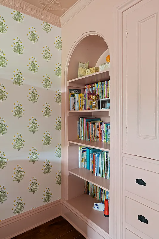 bedroom niche with shelving and built-in storage painted pink
