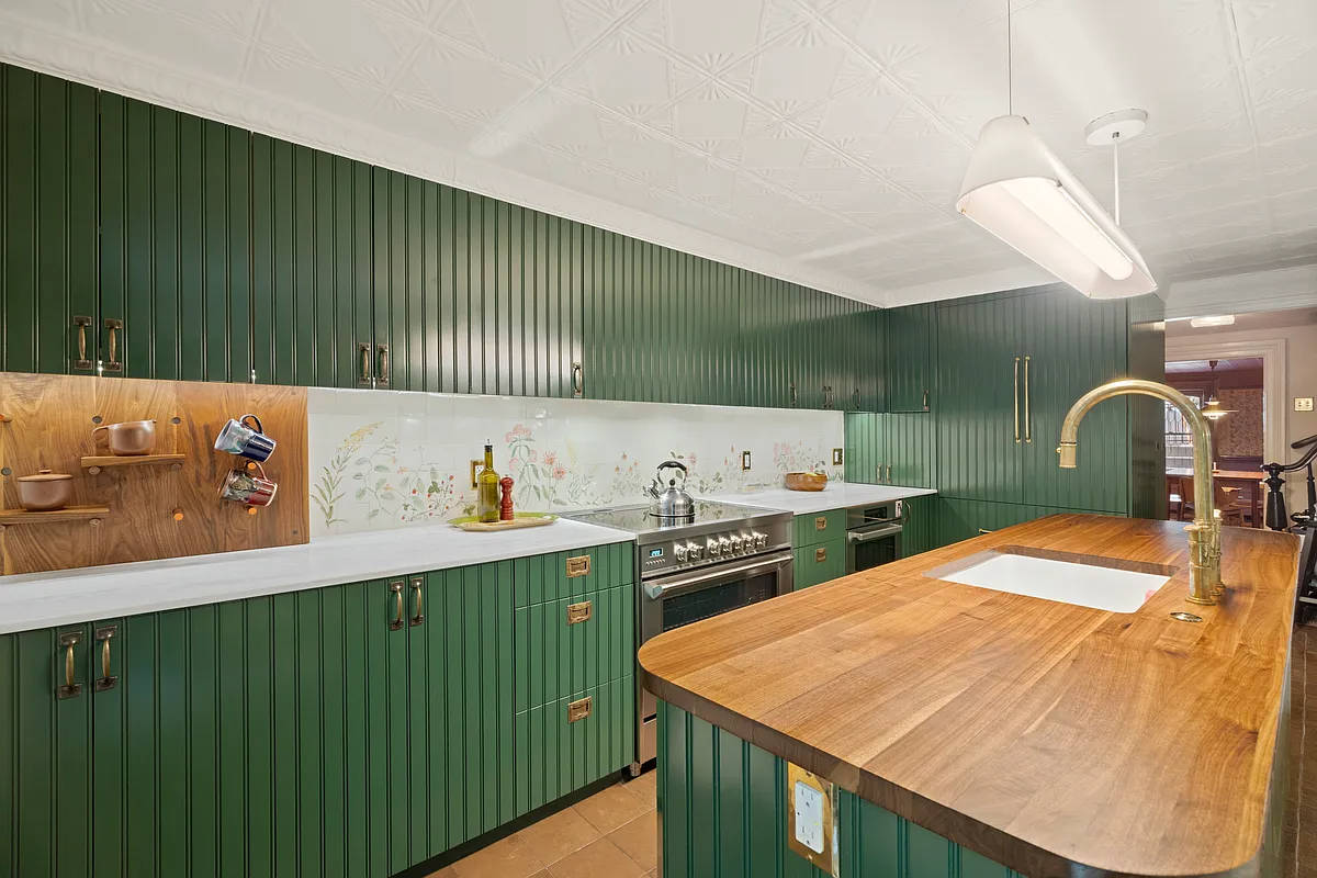 kitchen with green cabinets, tin ceiling, butcher block island