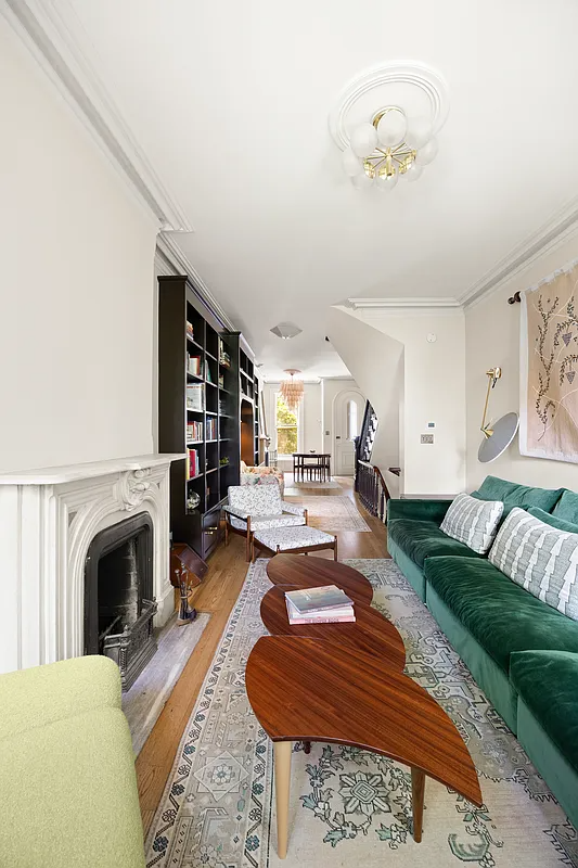 rear of parlor level with a marble mantel and room for a living area with sofa