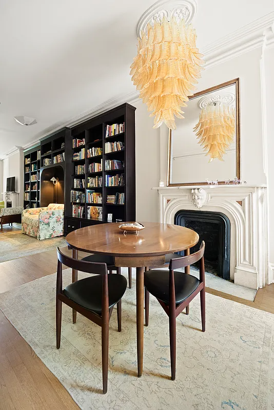 parlor level with a marble mantel, ceiling medallion and room for dining