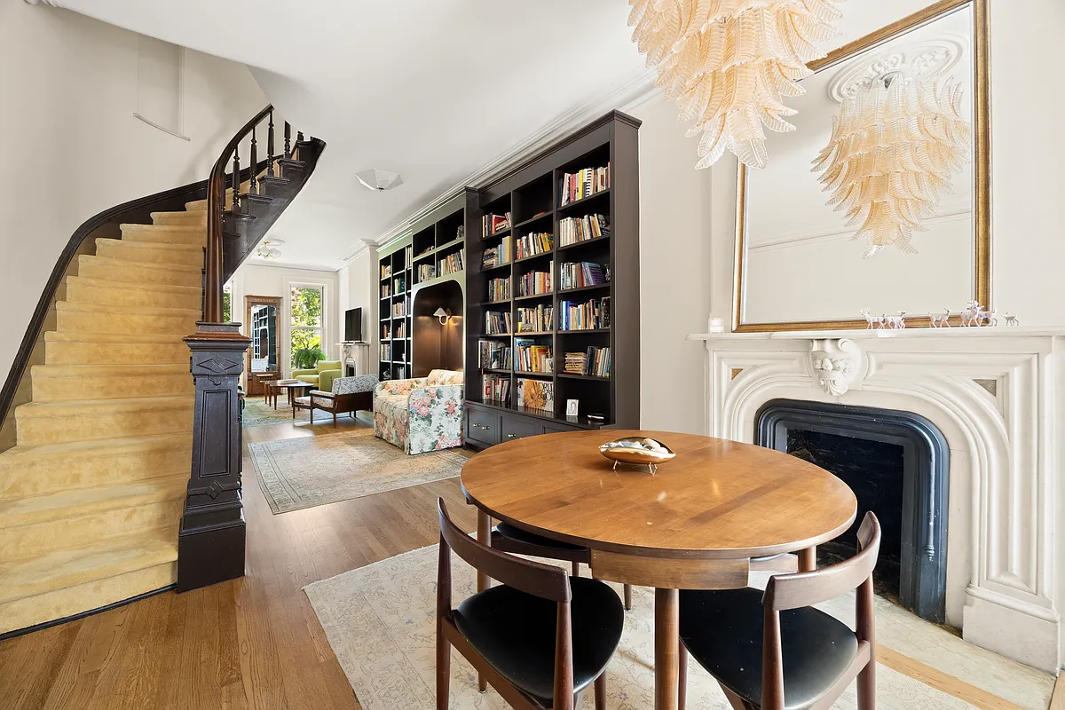 cobble hill - parlor level of a brownstone showing a curved stair and a marble mantel