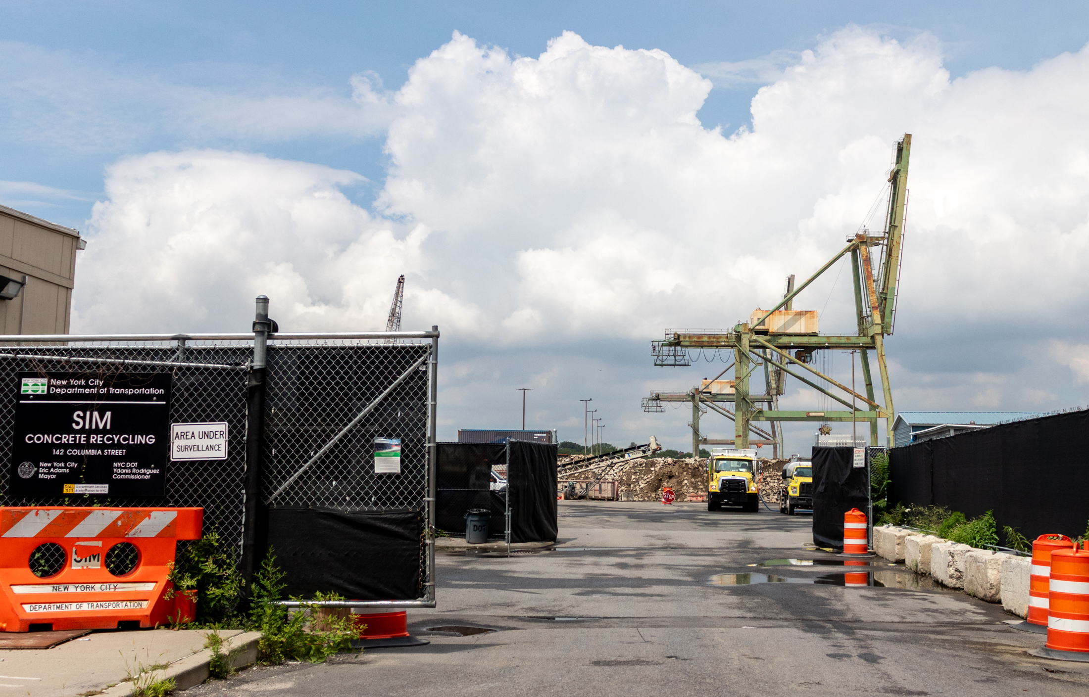 view through a fence to a crane on the waterfront