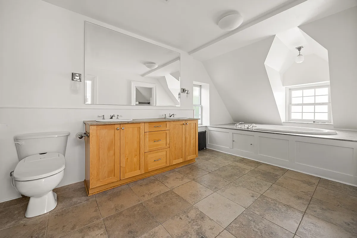 bathroom with soaking tub next to a window