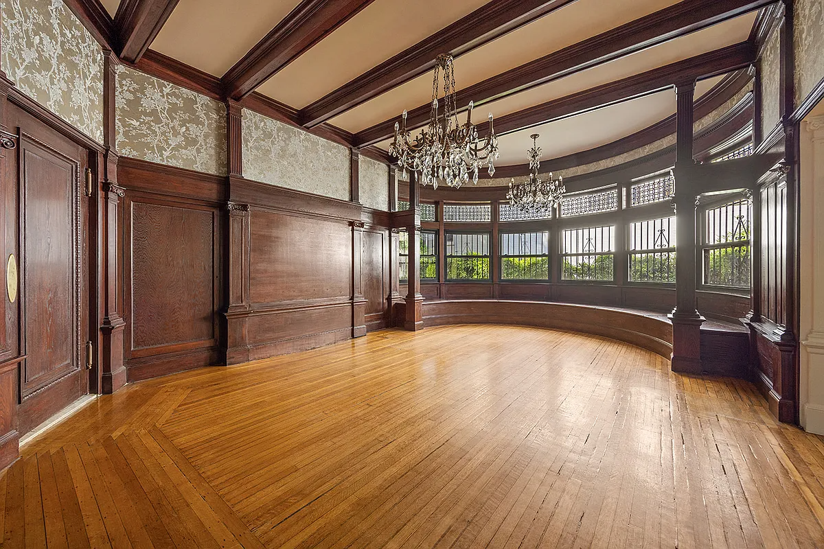 dining room with wainscoting, curved window seat