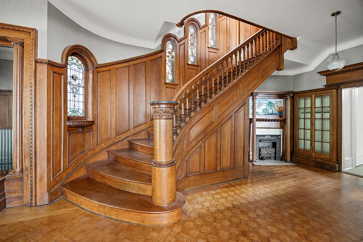 entry hall with original stair, wainscoting, stained glass, mantel