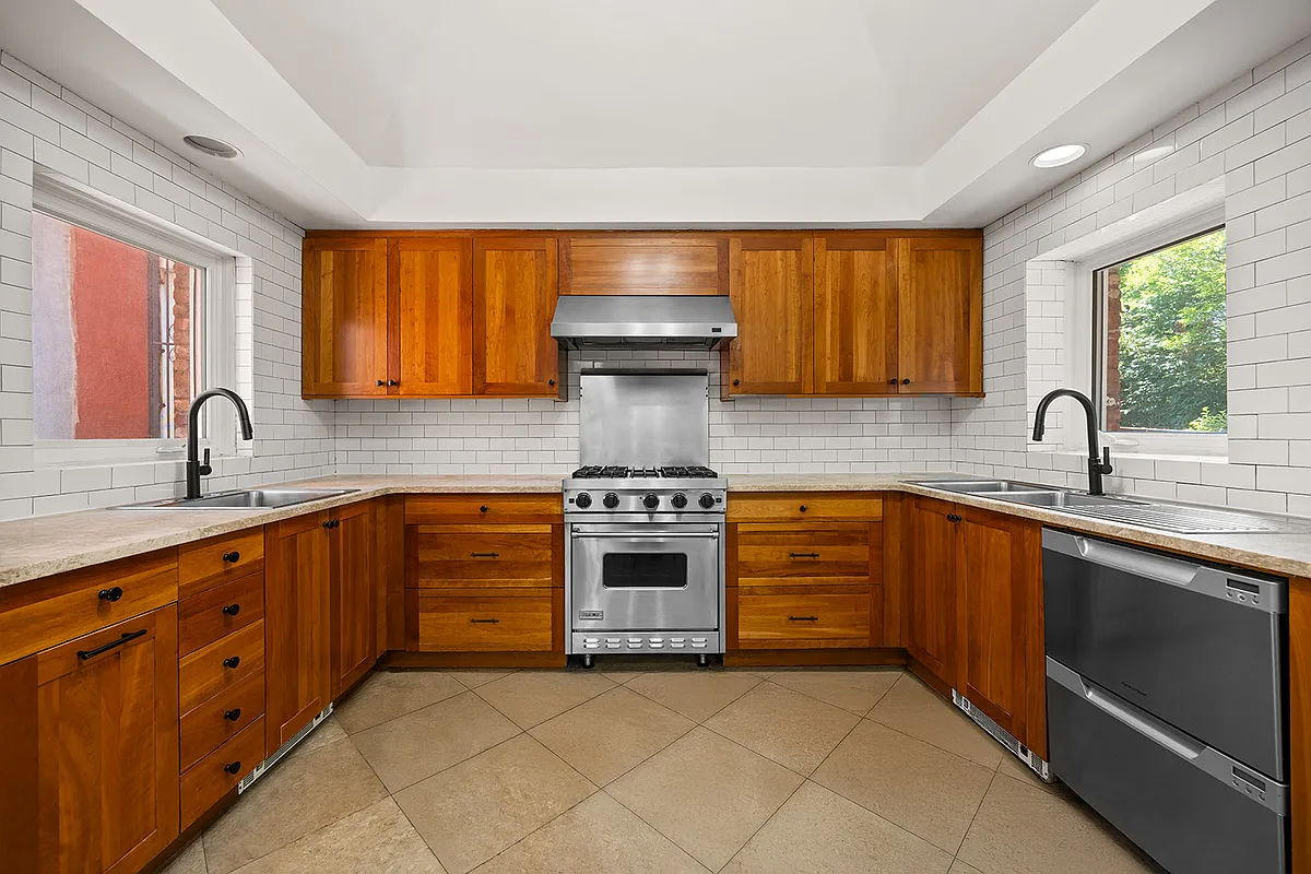 kitchen with subway tile on walls, wood cabinets