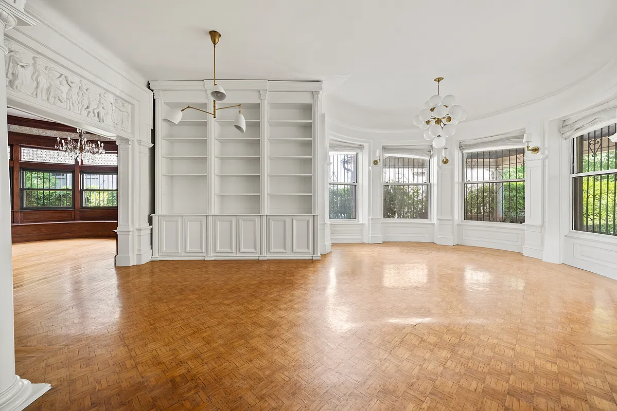 library with built-in bookcases, bay window