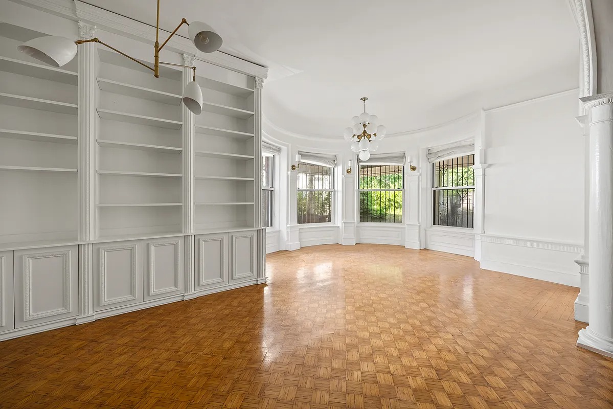 library with built-in bookcases, bay window