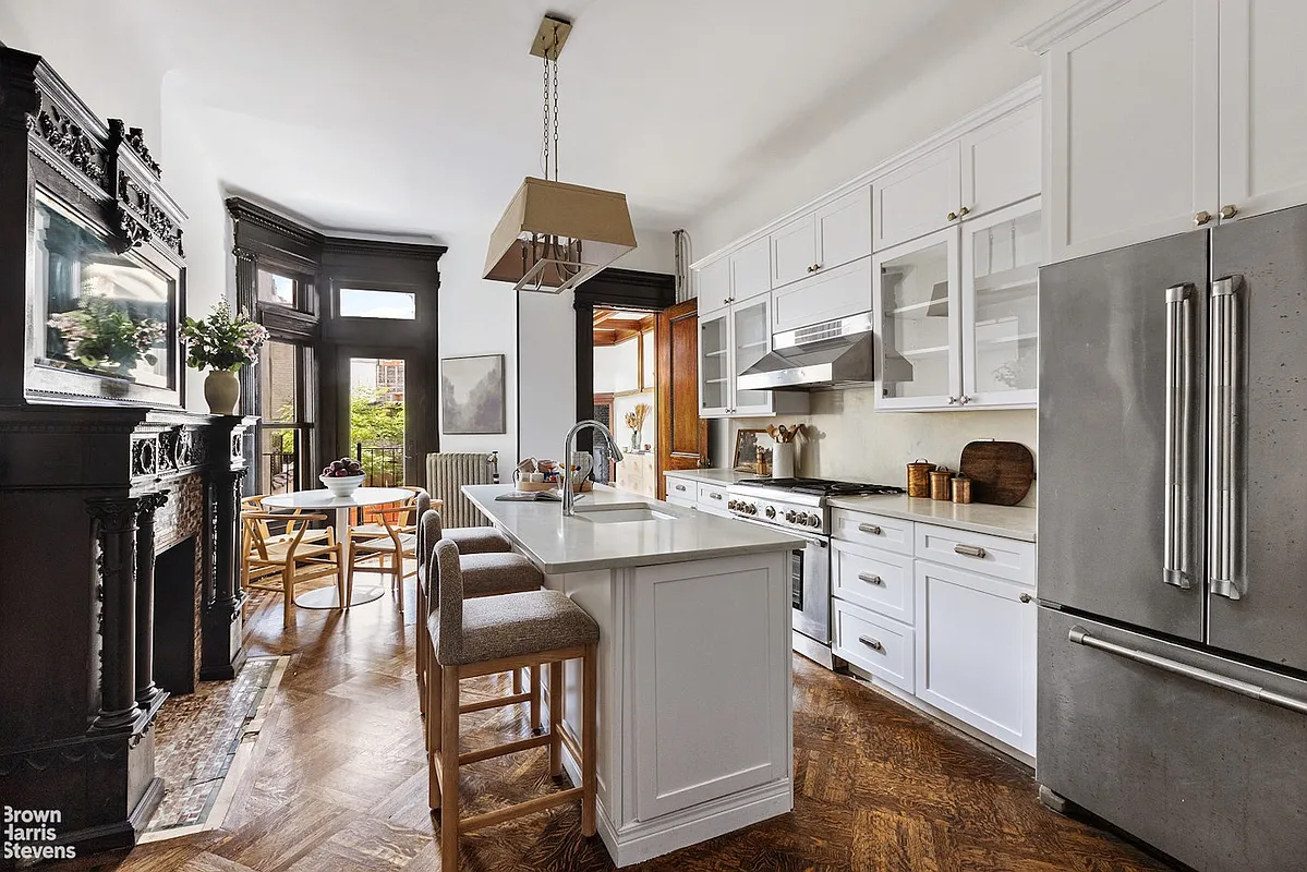 a kitchen with a mantel and white cabinets