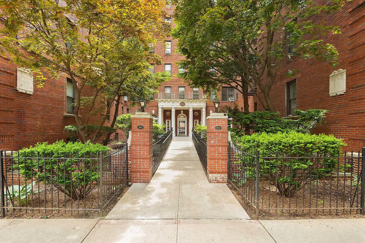 brick exterior with columned entry set back from sidewalk