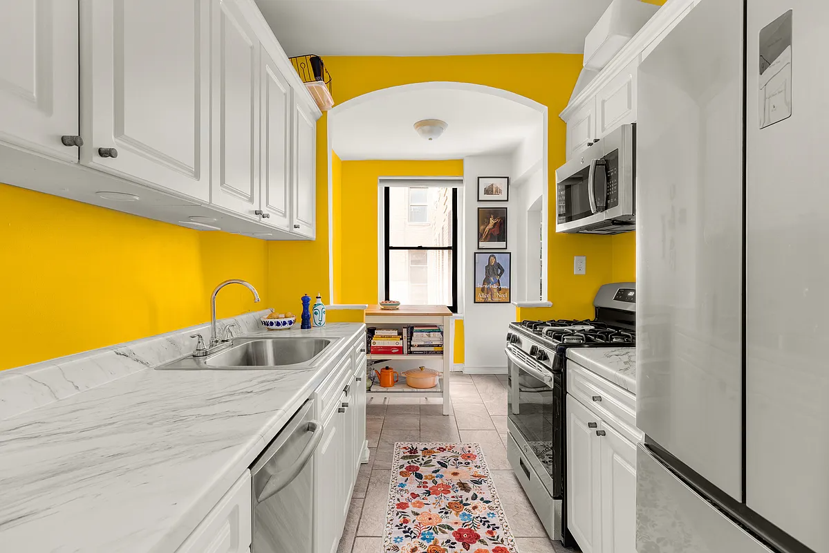 kitchen with yellow walls and white cabinets