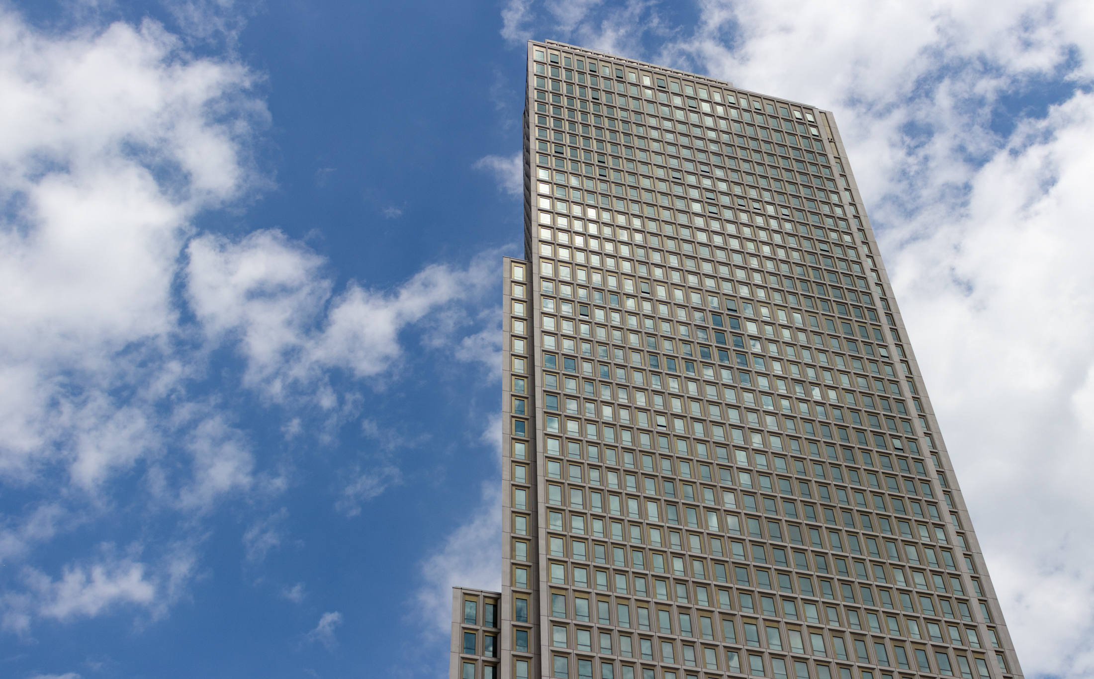 the top of the multi-story tower against a blue sky