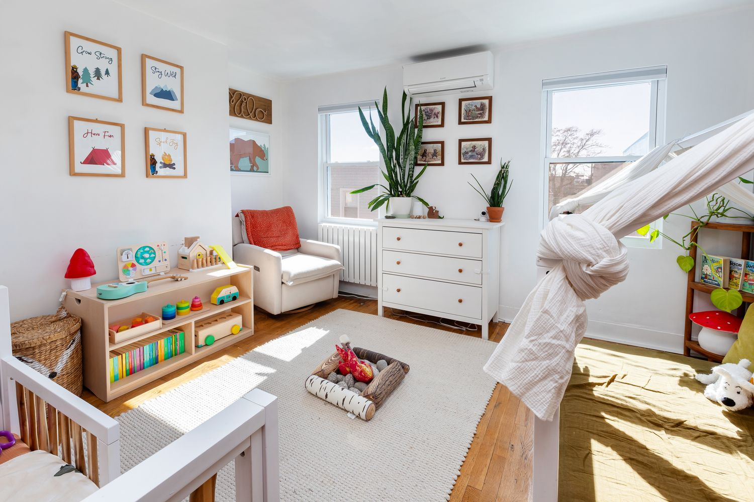 bedroom with wood floor, white walls, a mini split unit