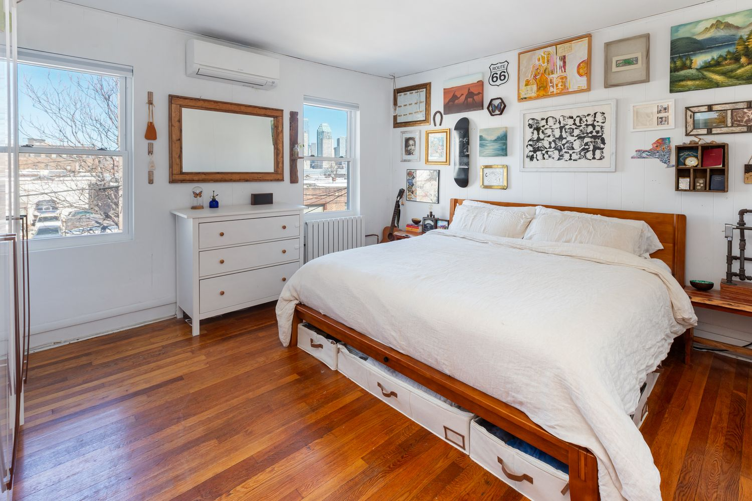 bedroom with wood floor, two windows