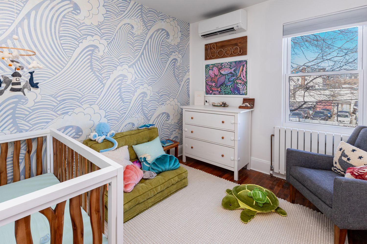 bedroom with a wall of blue wave wallpaper